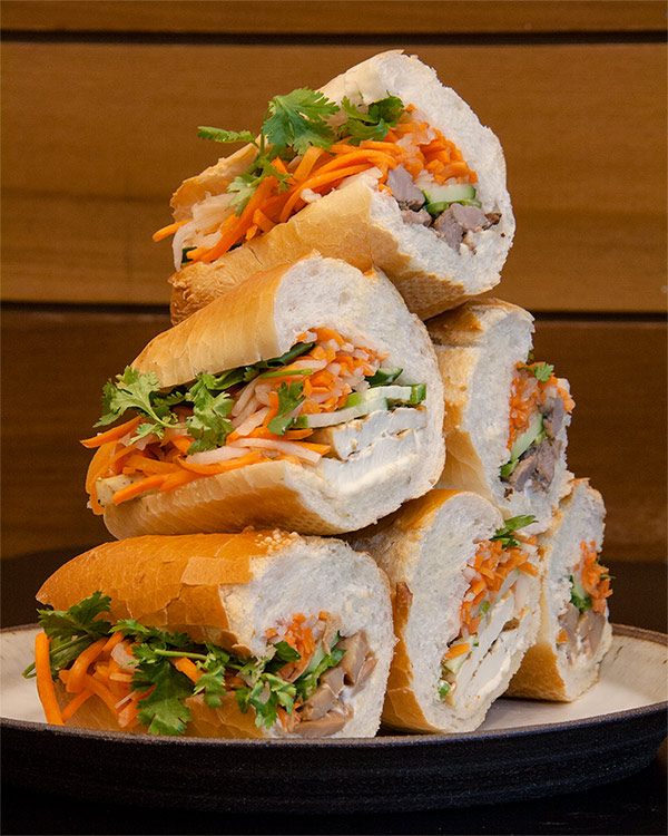 Stack of banh mi sandwiches in meat and meatless varieties